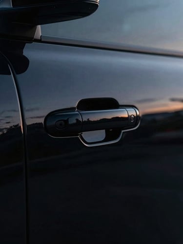 Moody cinematic close-up of a pristine black armored vehicle door handle, twilight reflections on polished obsidian paint, sharp rim lighting, 35mm