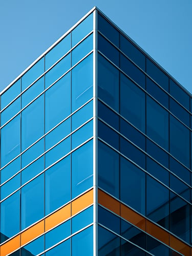 Macro close-up of a modern glass office building corner, sharp geometric angles and deep blue shadows, bright high-key daylight, architectural precision, 35mm.