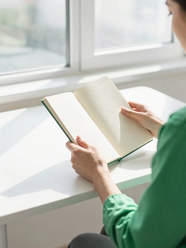 Active professional at a sunlit standing desk, morning light pouring through a window, holding a clean notebook, high-key lifestyle photography, crisp white and green accents