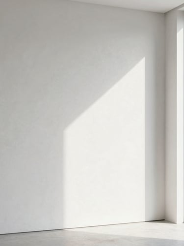 Minimalist architectural interior with a perfectly smooth plaster wall catching bright natural daylight from a large window, crisp textures, 35mm lens