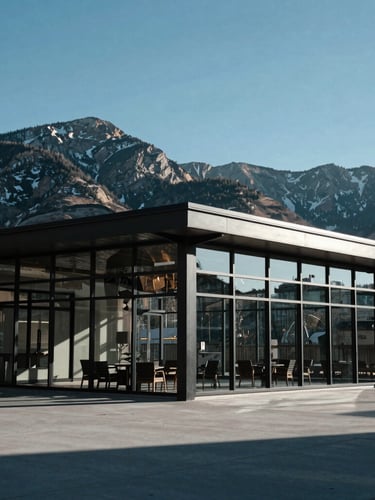 Wide architectural shot of a modern glass and steel pavilion in Park City, sharp mountain lines in the background, cool crisp daylight, 35mm
