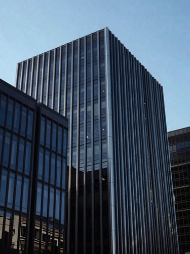 Wide environmental shot of sharp architectural lines of a modern office building in Park City, cool crisp daylight, deep blue and charcoal tones, high contrast, 35mm