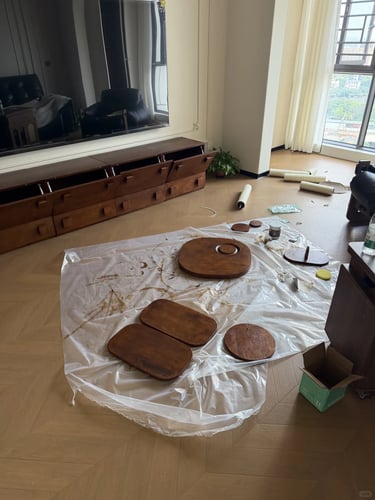Cat tree assembly parts laid out on the floor, showing wooden platforms, woven baskets and scratchin