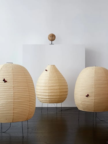 Group of glowing Akari paper lamps showing Isamu Noguchi’s soft light and organic sculptural forms