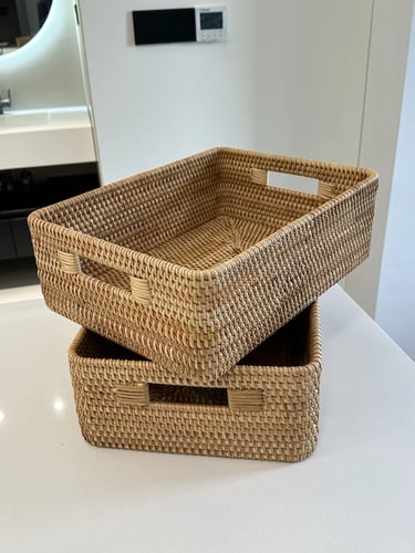 Stacked woven baskets for storing cat toys, pet supplies and everyday clutter in a small apartment.