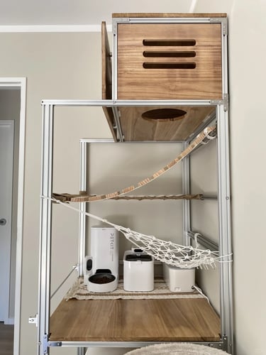 Compact cat furniture system with storage box, hammock and pet essentials grouped together to reduce