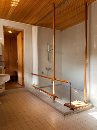 Warm bathroom interior with wood ceiling and natural details, reflecting Alvar Aalto’s use of honest