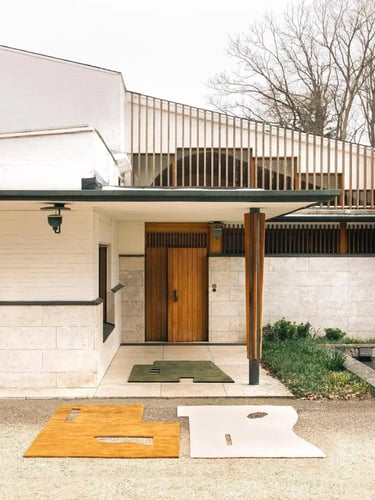 Alvar Aalto building exterior with clean white walls, wooden entrance and simple Nordic modern desig