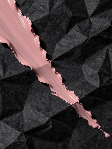 Extreme close-up, high-contrast chiaroscuro lighting. Abstract physical textures of crumpled black paper slashed with dusty rose paint, deep shadows, raw tactile digitalism, Dutch angle framing.