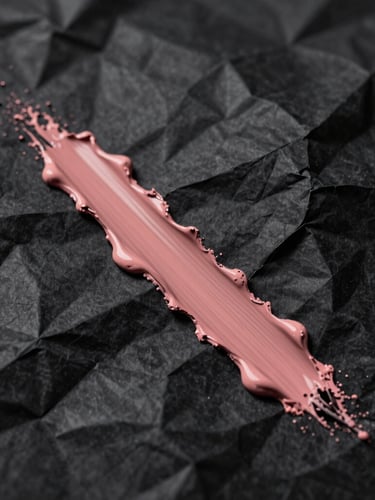 Extreme close-up of crumpled black paper slashed with a single streak of dusty rose paint, harsh flash lighting, deep shadows