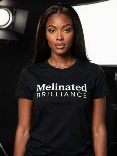 A Black woman wearing a black Zing Sinz t-shirt in a professional studio setting with lighting.