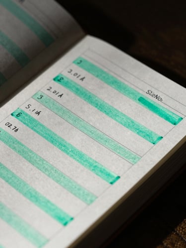 Extreme close-up of a physical planner with hand-drawn progress bars, high-contrast moody lighting, deep shadows, electric mint ink accents, sharp focus.