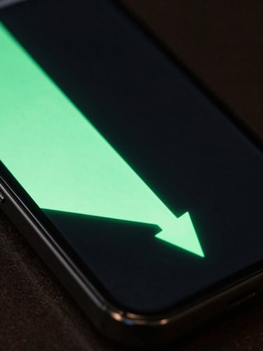 Extreme close-up of a smartphone screen showing a glowing progress graph with a sharp diagonal drop, cast in high-contrast mint green light and deep shadows.