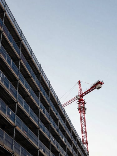 Low-angle architectural shot of structural scaffolding lines against the Melbourne morning sky, crisp daylight, desaturated navy and concrete tones with a sharp red crane in the distance.
