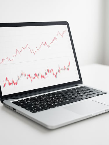 Macro shot of a sleek laptop displaying clean financial charts on a white desk, bright daylight, minimal composition with generous negative space, high-key lighting, sharp focus