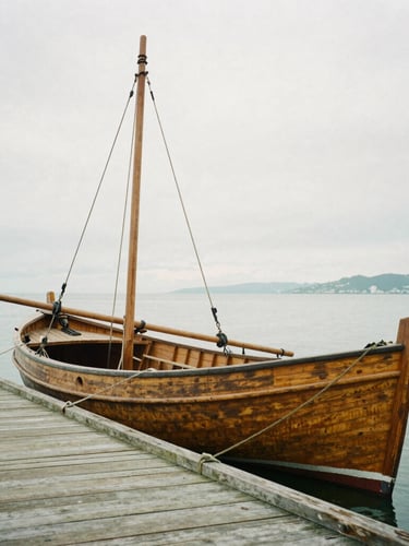 Medium shot of a historic wooden skipjack boat docked at a weathered pier, soft overcast coastal light, desaturated earth tones, 35mm lens