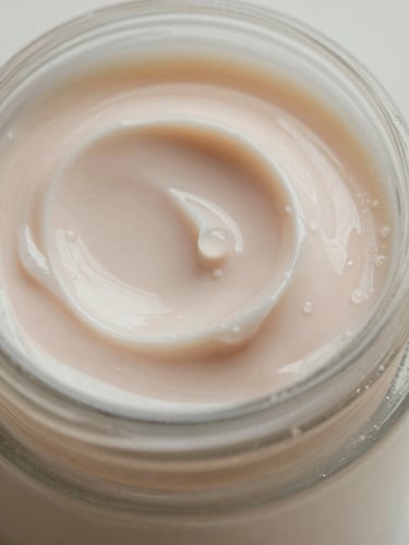 Extreme close-up of a smooth, dewy vegan face cream texture with soft morning light reflections and clean glass bottle edge