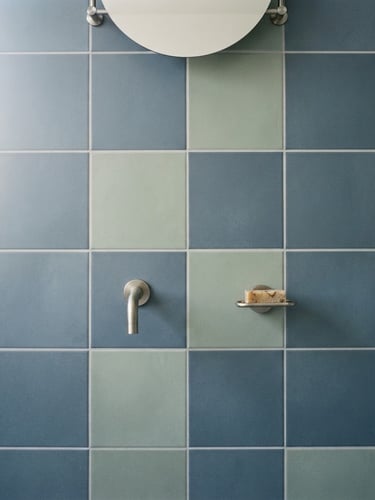 Symmetrical architectural close-up of perfectly aligned large-format ceramic tiles in a modern bathroom, sharp grout lines, bright natural daylight, 35mm