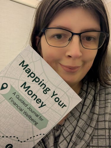 Bex holding the Mapping Your Money guided journal.