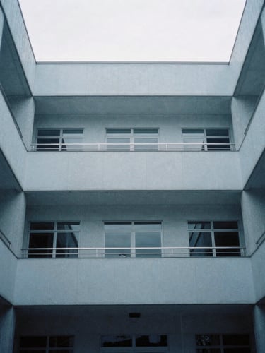 Architectural interior of a modern consular building, sharp lines, diffused light, cool desaturated blue tones, 35mm, centered