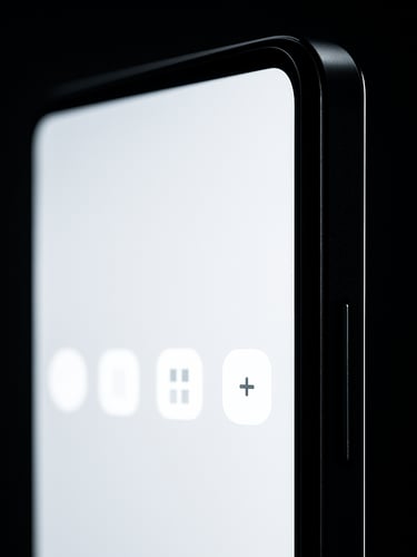 Close-up portrait of an Android phone screen edge-on, a clean minimal UI visible on the display, studio lighting with high contrast against a near-black background, tight crop showing only the device and the glowing interface detail