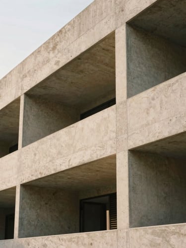 Abstract close-up of contemporary architectural concrete lines under soft natural overcast daylight, emphasizing negative space and structural order