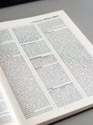 Extreme close-up of an official French Journal Officiel page lying flat on a grey government desk, tight crop on dense printed text columns and a publication date stamp, neutral daylight from the left, high contrast black ink on white paper