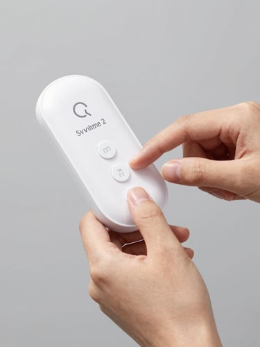 Upload approved SmartCane Device 2 photograph showing hands interacting with the tactile buttons, clean neutral gray background.