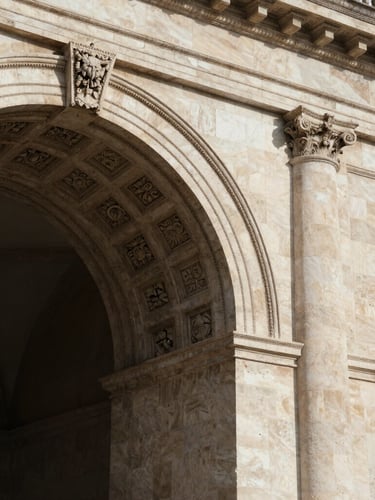 An architectural detail of a historic stone archway with classical carvings, soft directional natural light casting deep shadows, elegant and prestigious feeling.