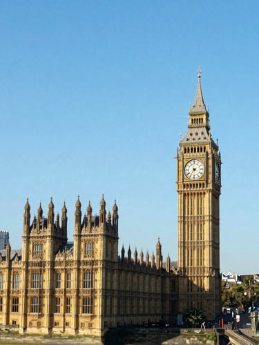 Wide-angle vibrant shot of the London skyline with the Big Ben and Westminster Bridge under bright clear daylight
