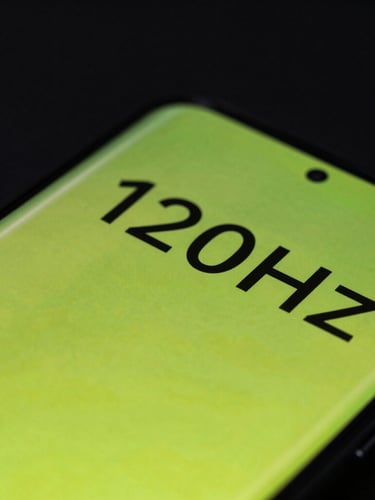 Macro close-up of a flagship Android phone screen under moody cyber-lime neon glare, showing a fluid 120Hz UI transition with sharp vector geometry, high-contrast reflections on the glass.