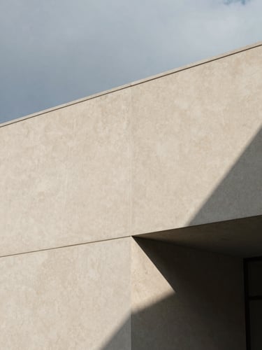 Architectural close-up of sharp geometric shadows casting on a warm alabaster concrete wall, minimalist corporate aesthetic, 35mm