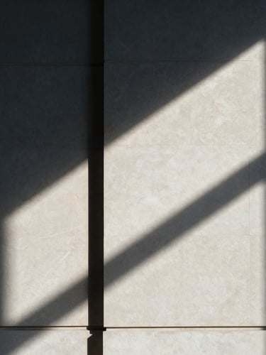 Macro architectural photograph of sharp geometric shadows casting across a limestone legal office wall, high-contrast natural light, professional minimal aesthetic, 35mm