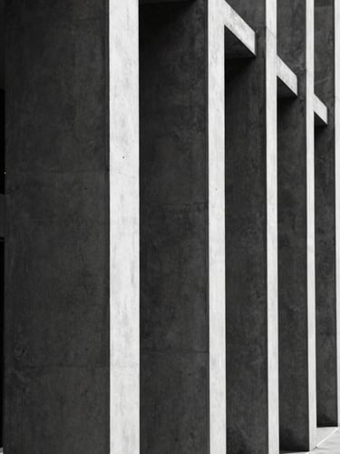 Tight vertical crop of modern concrete and steel architectural columns, stark shadows, high contrast black and white, minimal composition