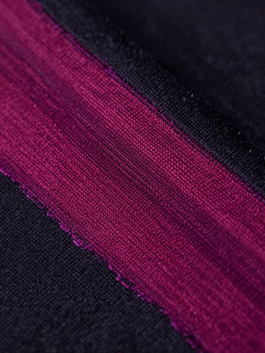 Extreme close-up of vibrant magenta ink on dark cotton fabric, showing rich textile fiber detail under sharp studio lighting, 50mm