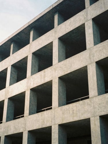 Detail of structured concrete and steel architecture, clean geometric shadows, soft overcast daylight, medium format film style.