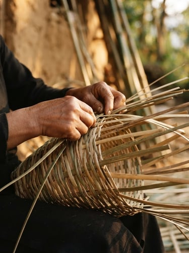 Close-up of hands weaving wild-harvested ringal bamboo under soft golden-hour side lighting, warm editorial style, shallow depth of field