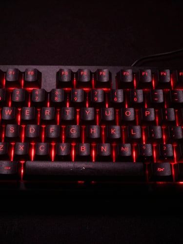 Portrait shot of a high-end mechanical gaming keyboard, dramatic red backlighting, high-contrast dark shadows, raw low-key gaming aesthetic, 35mm lens