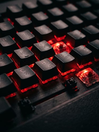 Extreme close-up of a mechanical gaming keyboard illuminated by intense red backlighting, dark shadows, low-key cyber-brutalist aesthetic