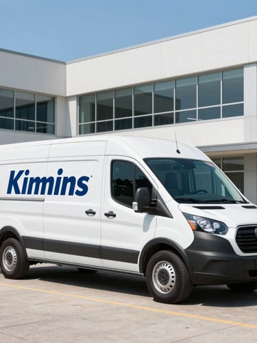 A branded Kimmins delivery van parked in front of a modern Western New York business park under bright, clear daylight, 35mm lens.
