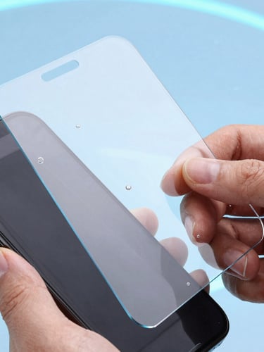 Macro shot of hands applying a tempered glass screen protector to a smartphone, zero bubbles, bright studio lighting with cool blue backlighting.