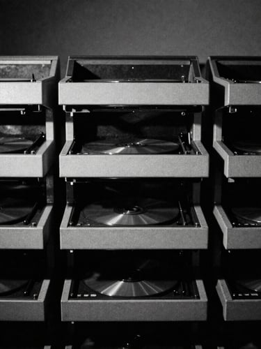 Harsh high-contrast monochrome photo of industrial CD duplicators, heavy shadows, photocopy texture, 35mm film grain, brutalist grid composition