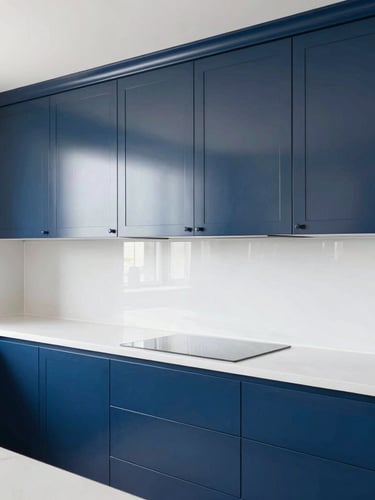 Clean architectural shot of a modern kitchen with freshly sprayed navy blue cabinets, bright natural daylight reflecting off the flawless semi-gloss cured coatings