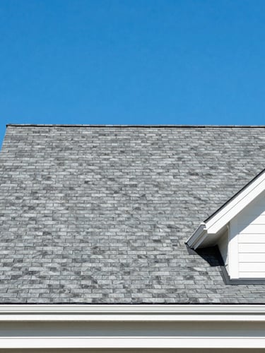 Straight-on architectural shot of a pristine shingle roof on a modern mountain home in Asheville, bright midday sun, deep blue sky, clean lines