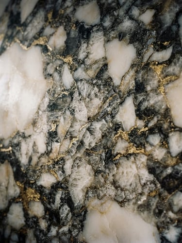 Extreme close-up of premium Italian Calacatta marble with dramatic gold and charcoal veins, low-key side-lighting emphasizing polished stone texture, sharp focus