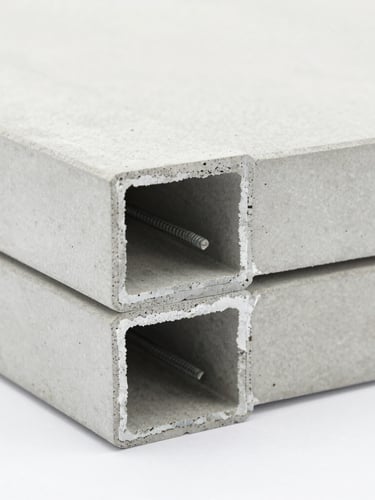 Close-up macro shot of a Citikon lightweight concrete floor panel interlocking joint, showing the precise groove and steel reinforcement inside, bright clean studio lighting, architectural focus.