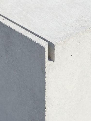 Close-up of lightweight concrete panel interlocking joint, showcasing the high-precision engineered texture, bright studio lighting, clean architectural detail
