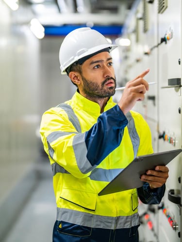 Electrical engineer in a hard hat inspecting