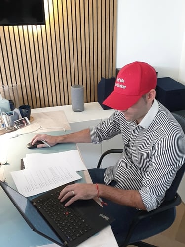 Adam Day reviewing property documents at his Dubai office desk