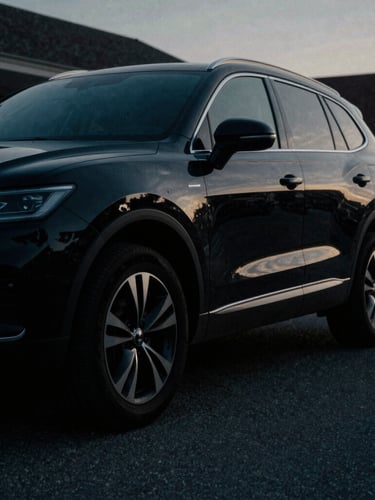 A low-angle, cinematic shot of a sleek, unmarked black SUV, partially obscured by shadow, parked on a quiet Alexandria street at dusk, cool desaturated tones, dramatic directional light, sharp focus, 35mm film grain, cinematic shadows.